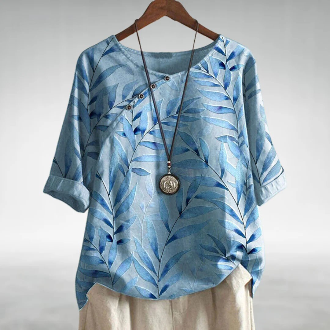 Blouse femme à coupe fluide avec détails uniques, idéale pour des occasions élégantes. 0