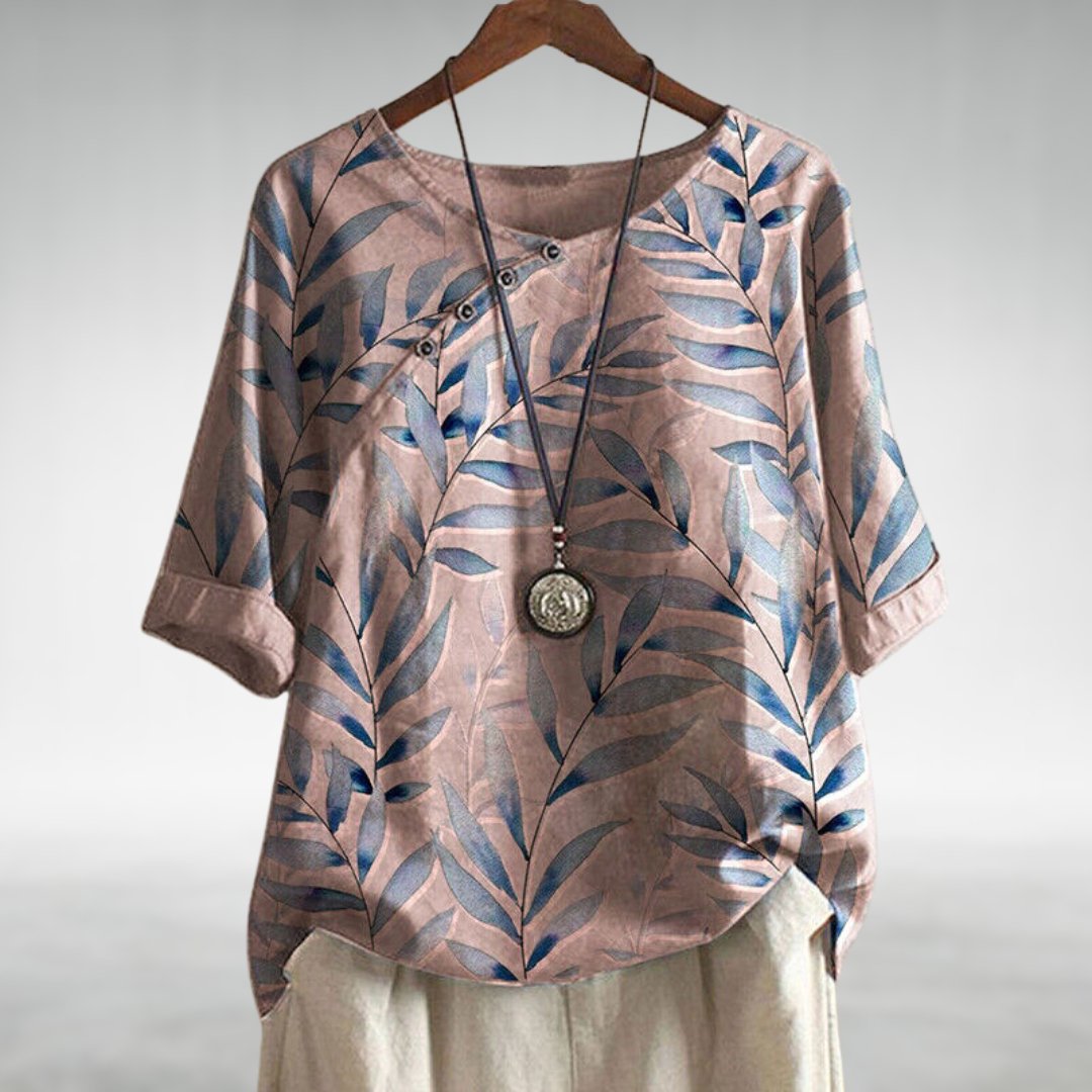 Blouse femme à coupe fluide avec détails uniques, idéale pour des occasions élégantes. 1
