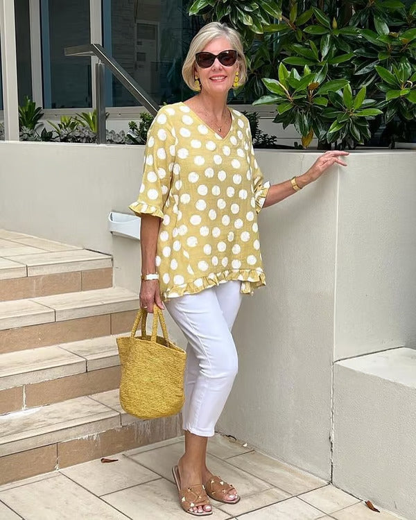 Chemisier femme chic, silhouette fluide, col en V et motif à pois. 1
